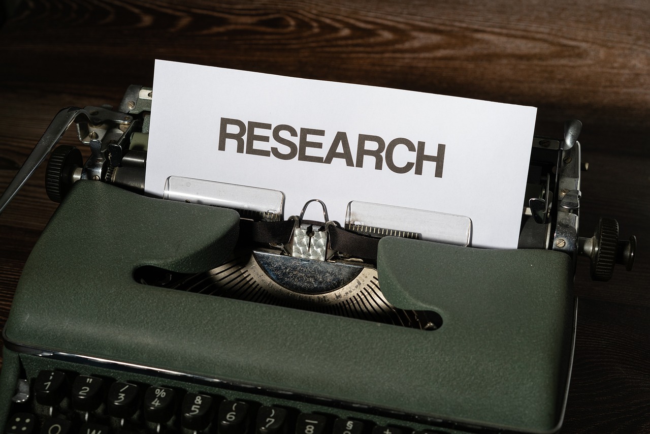 Research paper in a typewriter representing studies on menopausal hormone therapy
