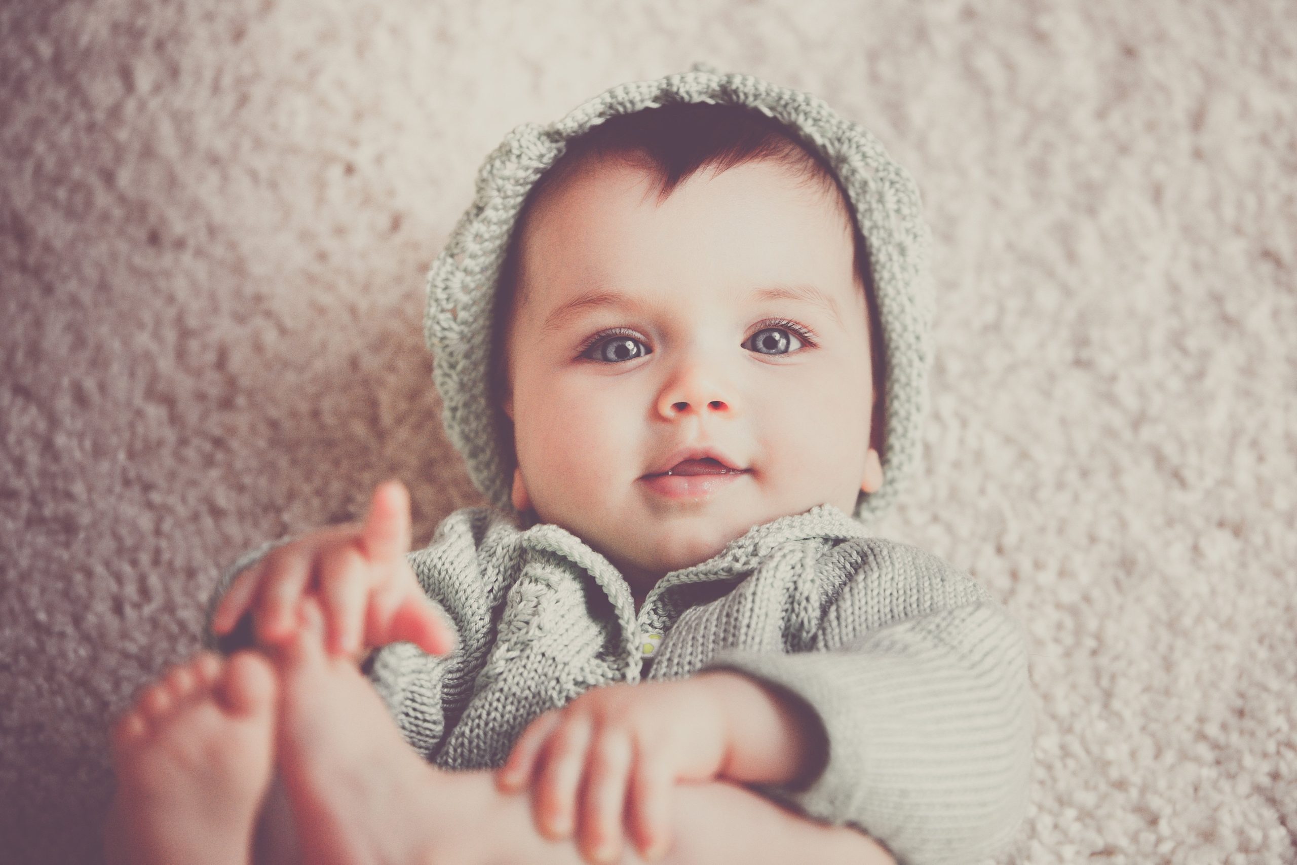 Breastfeeding and Lactation Support in Chinese Medicine Baby wearing a knitted cap, representing breastfeeding and lactation support in Chinese medicine