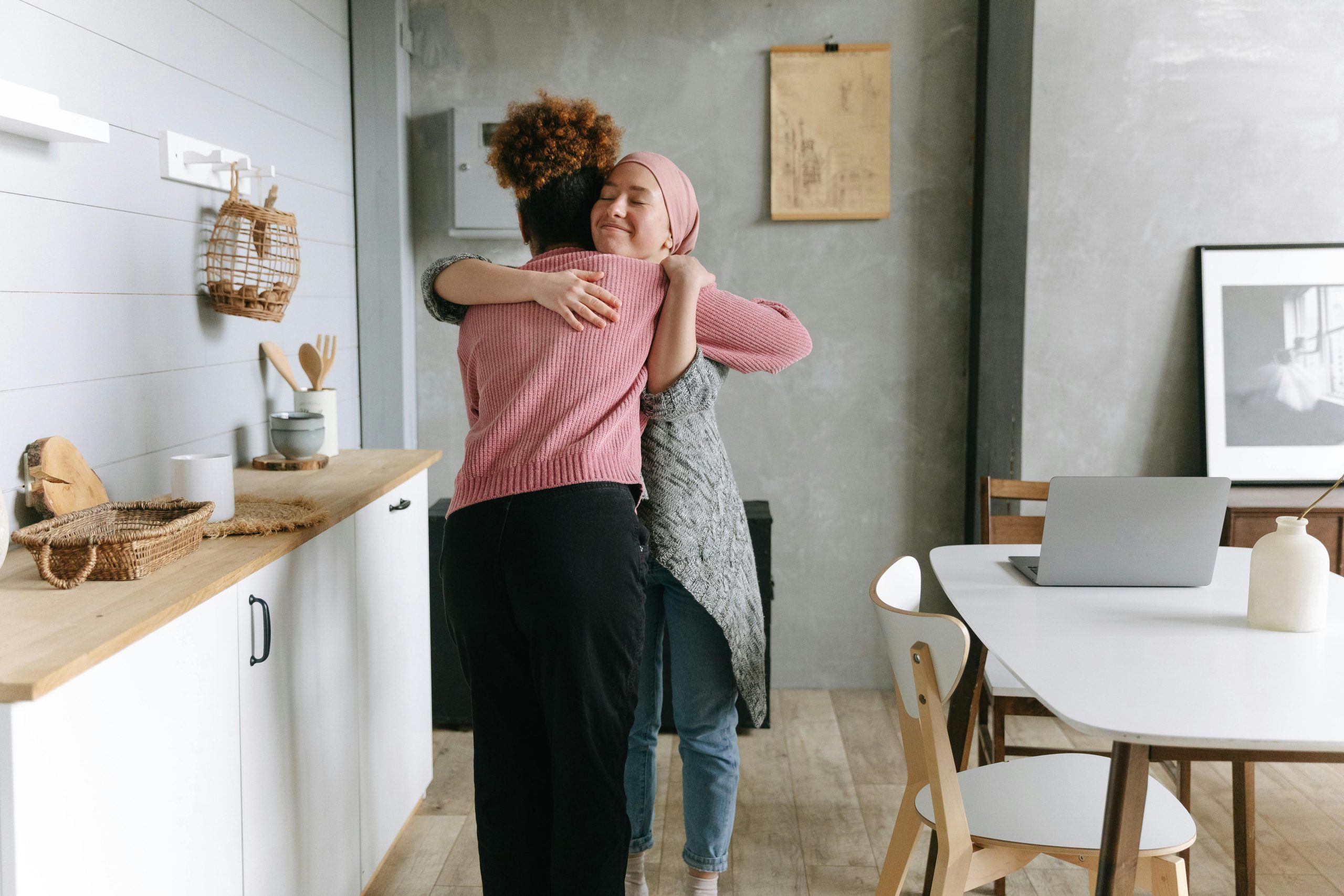 Two people embracing and offering support during cancer