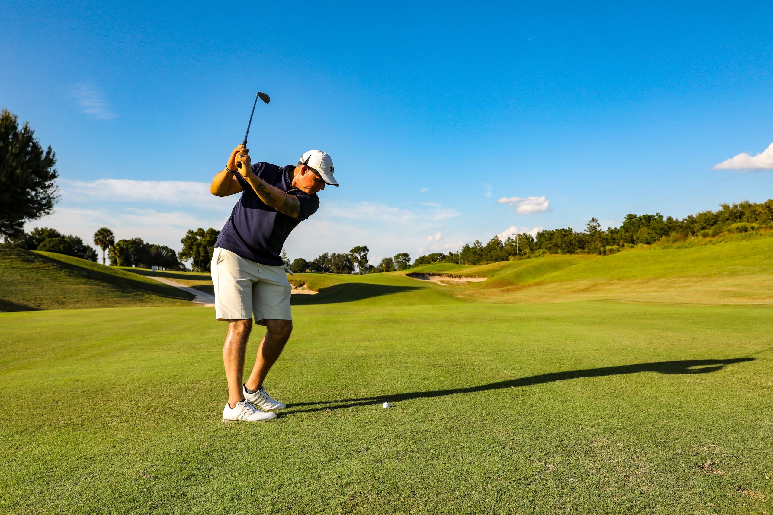 Right-handed golfer demonstrating lead-leg loading associated with left Achilles pain